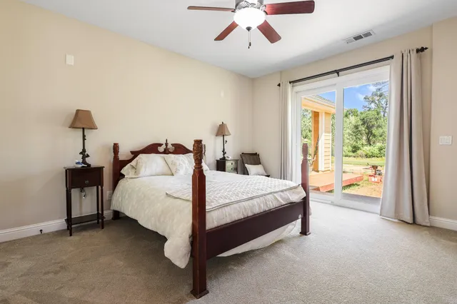 a spacious bedroom with a bed and a chandelier