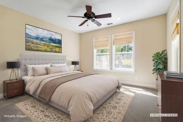 a bedroom with a bed and a painting on the wall