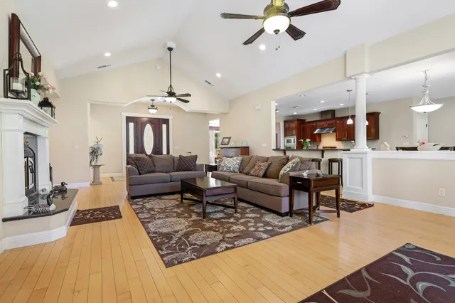 a living room with furniture and a chandelier