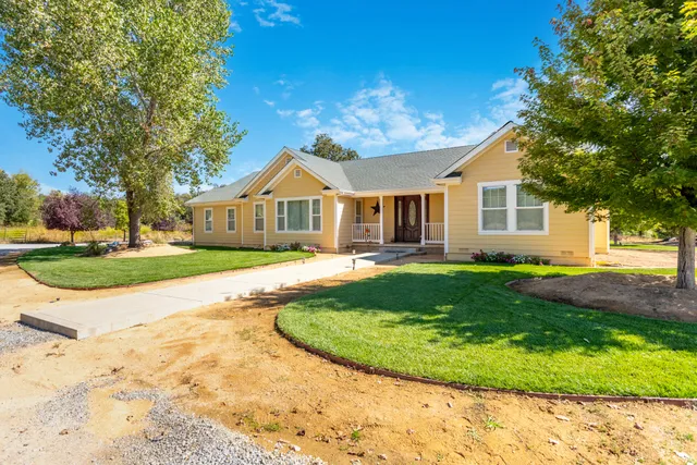 a view of house with a garden and pathway