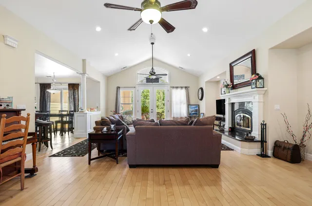 a living room with furniture fireplace and window