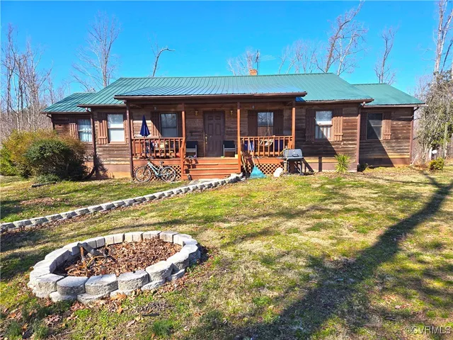 a front view of a house with swimming pool having outdoor seating