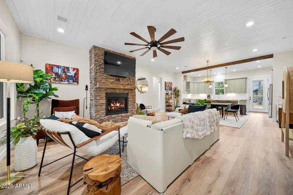 a kitchen with a dining table chairs and white cabinets