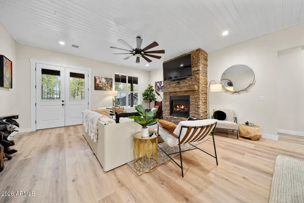 a kitchen with kitchen island a dining table chairs sink and wooden floor