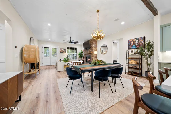 a kitchen with stainless steel appliances granite countertop a refrigerator a oven a stove and a wooden floors