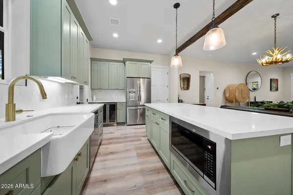 an entryway with wooden floor and mirror