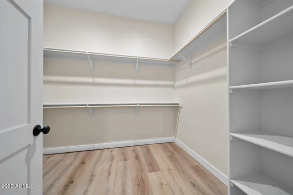 a view of a hallway with furniture and a chandelier