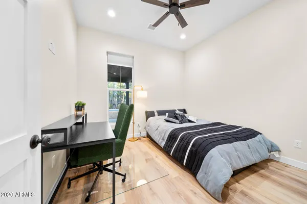 a bedroom with a bed and wooden floor
