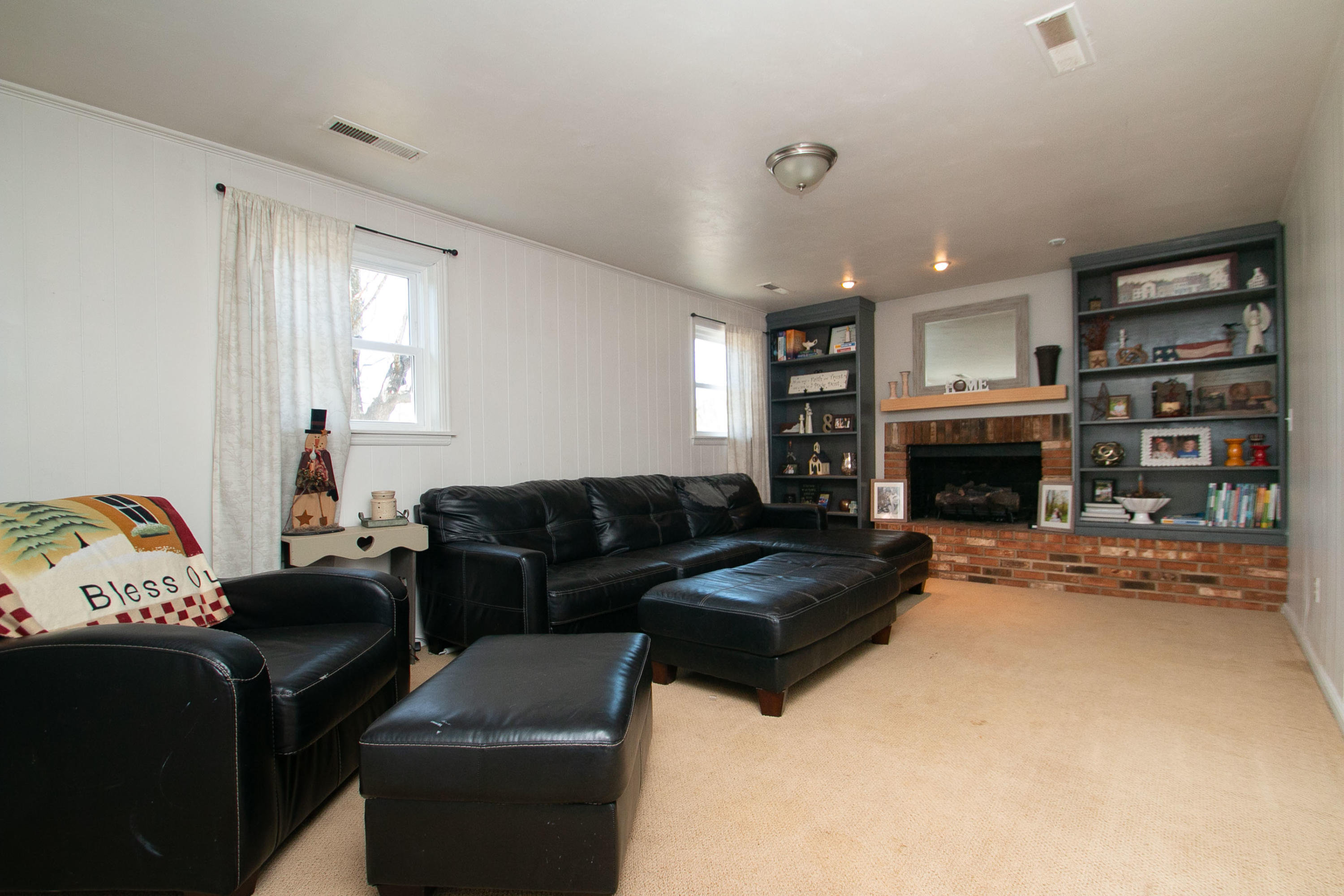 3022 Bandy Road Roanoke, VA 24014 - Photo 29 of 50 a living room with furniture a fireplace and a flat screen tv