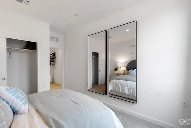 a bedroom with a bed and a mirror
