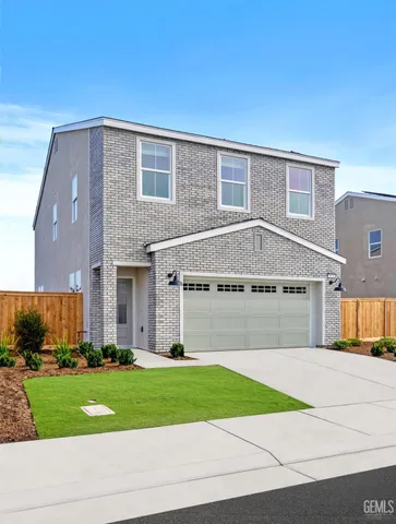 a front view of a house with a yard and a garage