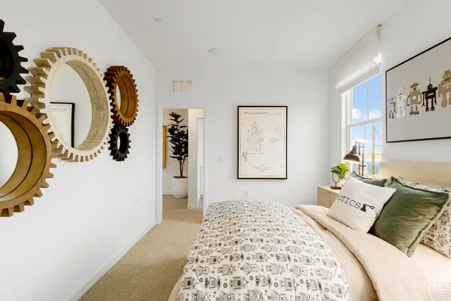 a bedroom with a bed and a painting on the wall