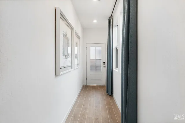 a view of a hallway with wooden floor