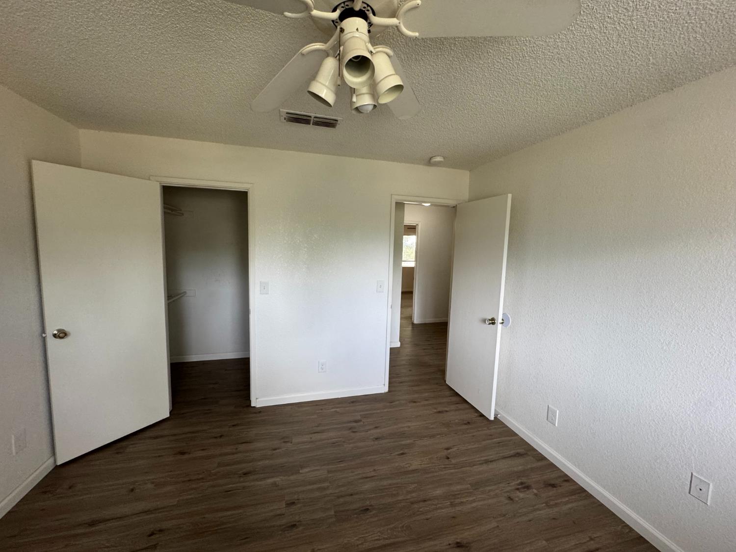 21293 East American Avenue Reedley, CA 93654 - Photo 6 of 19 wooden floor in an empty room with a window