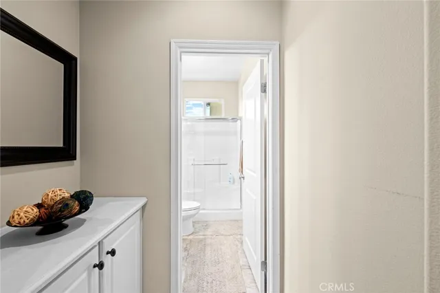 a bathroom with a toilet a sink and a mirror