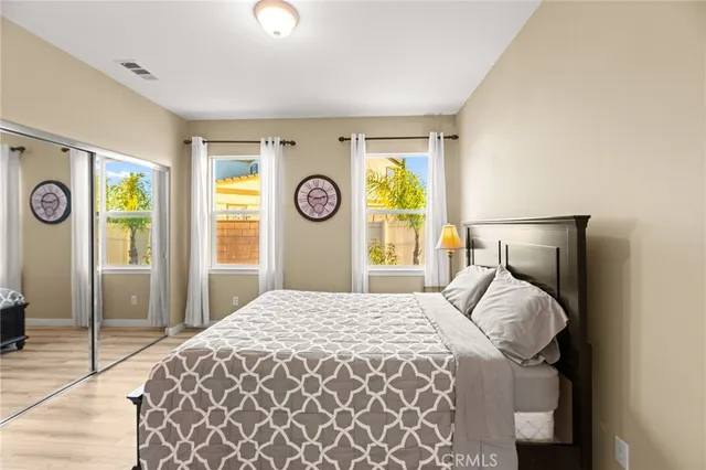 a view of a hallway with wooden floor and stairs