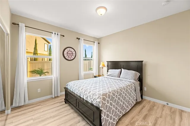 a bedroom with a large bed and a wooden floor