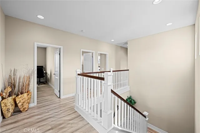 a view of a hallway view with wooden floor and living room