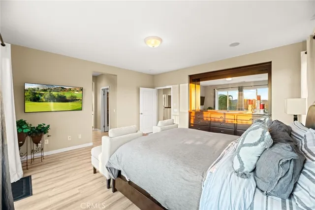 a bedroom with a bed and a mirror on dresser