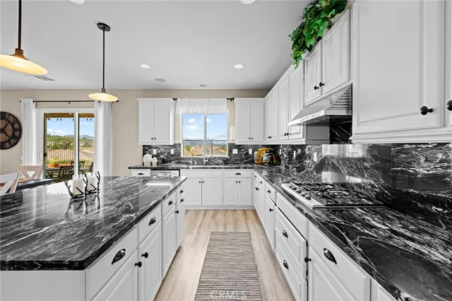a kitchen with a stove and cabinets