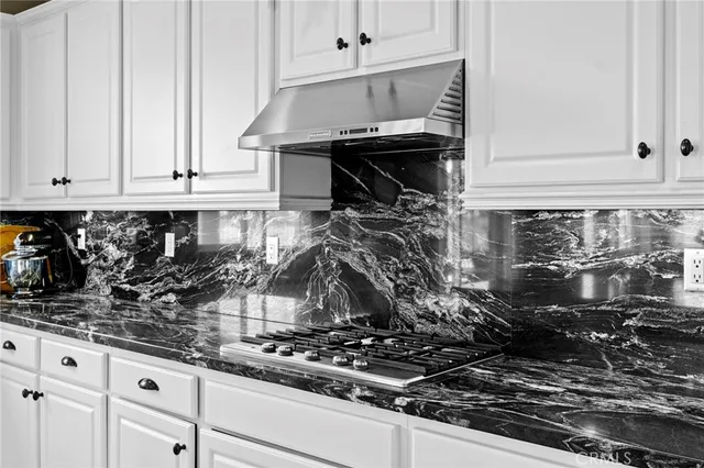 a kitchen with a sink a counter top space and cabinets