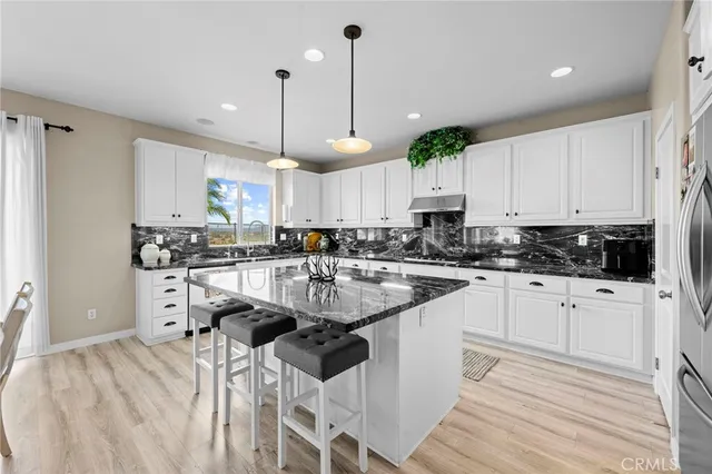 a living room with furniture a window and kitchen view