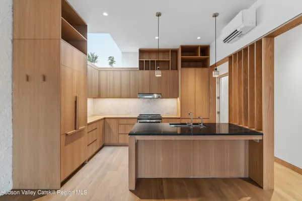 a kitchen with stainless steel appliances granite countertop a stove and a refrigerator