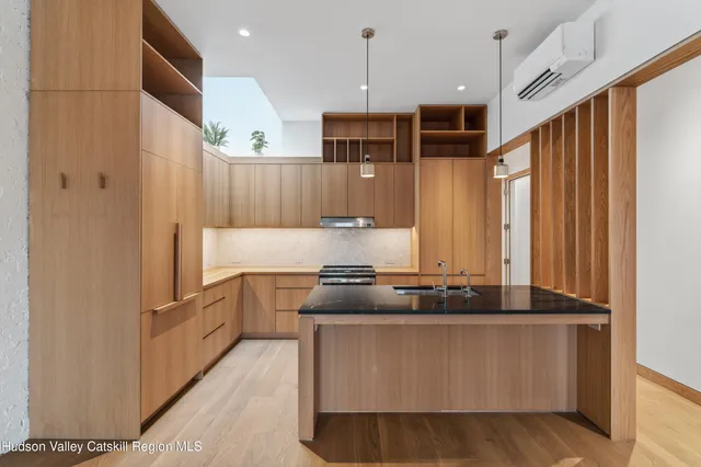 a kitchen with stainless steel appliances granite countertop a stove and a refrigerator