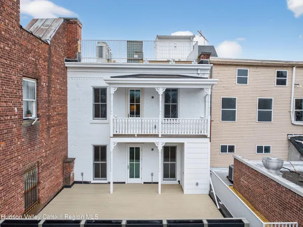 a view of a white building with many windows