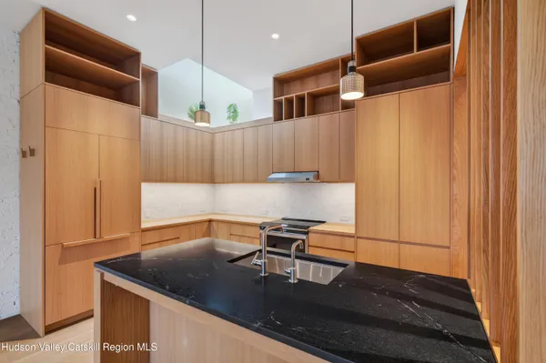 a kitchen with a sink a refrigerator and a stove