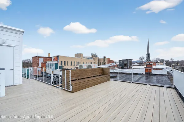 a view of a balcony with wooden floor