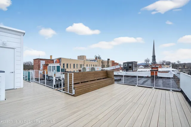 a view of a balcony with wooden floor
