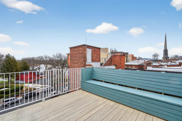 a view of balcony with wooden floor and fence