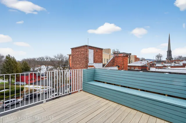 a view of balcony with wooden floor and fence