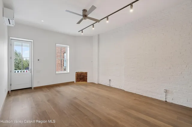 wooden floor in an empty room with a window