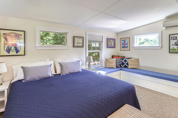 217 Barnes Road Oak Bluffs, MA 02557 - Photo 44 of 60 a bedroom with a bed and wooden floor