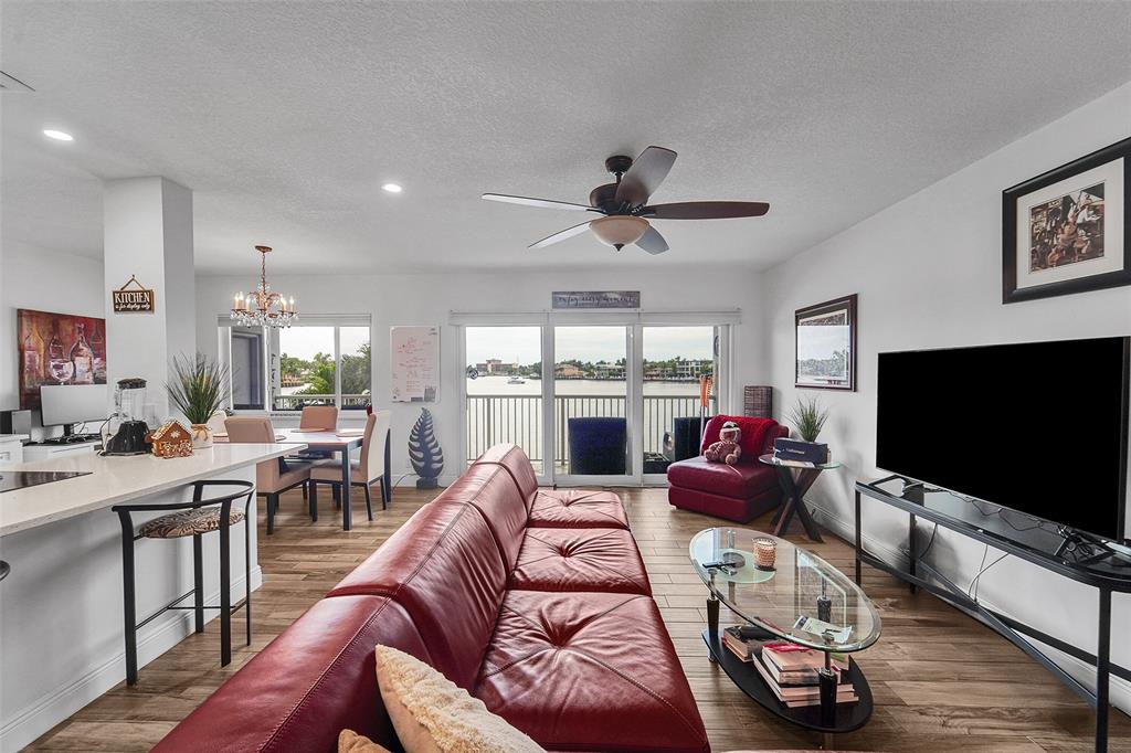 1201 South Riverside Drive, Unit 204 Pompano Beach, FL 33062 - Photo 11 of 48 a living room with furniture a flat screen tv and a large window