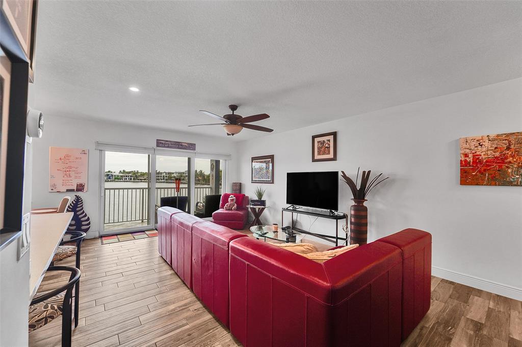 1201 South Riverside Drive, Unit 204 Pompano Beach, FL 33062 - Photo 13 of 48 a living room with furniture a flat screen tv and a fireplace