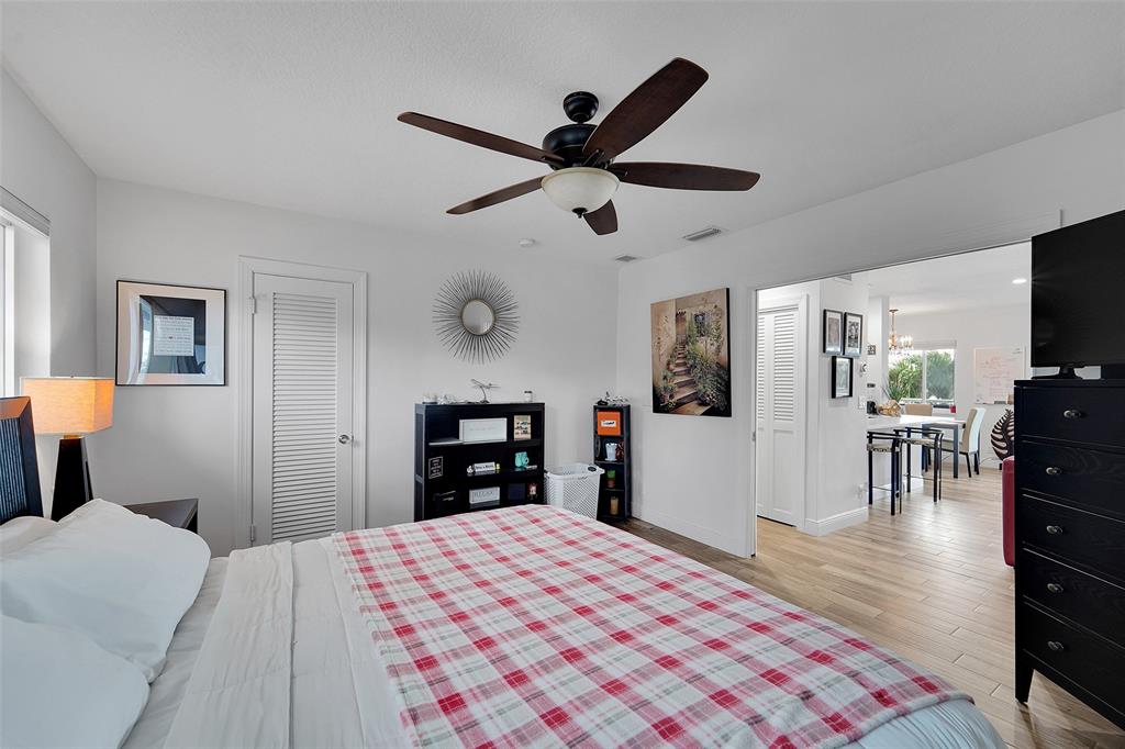 1201 South Riverside Drive, Unit 204 Pompano Beach, FL 33062 - Photo 21 of 48 a bedroom with a bed and a flat screen tv