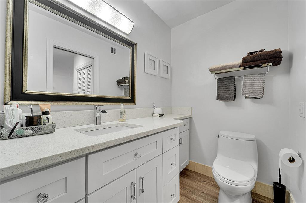 1201 South Riverside Drive, Unit 204 Pompano Beach, FL 33062 - Photo 22 of 48 a bathroom with a toilet a sink and mirror