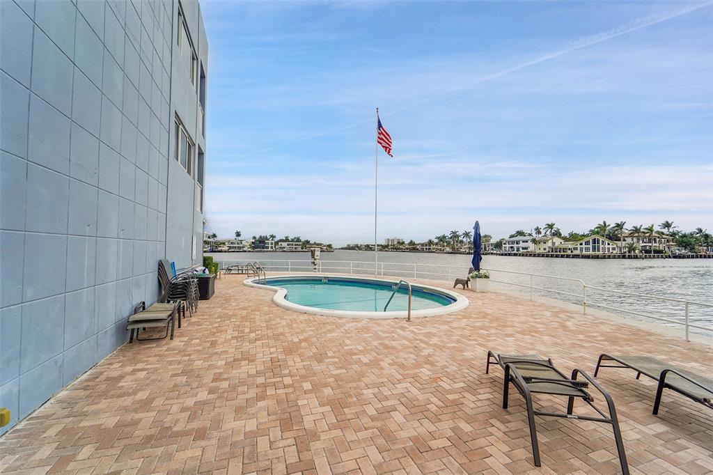 1201 South Riverside Drive, Unit 204 Pompano Beach, FL 33062 - Photo 24 of 48 a view of swimming pool with outdoor seating and yard