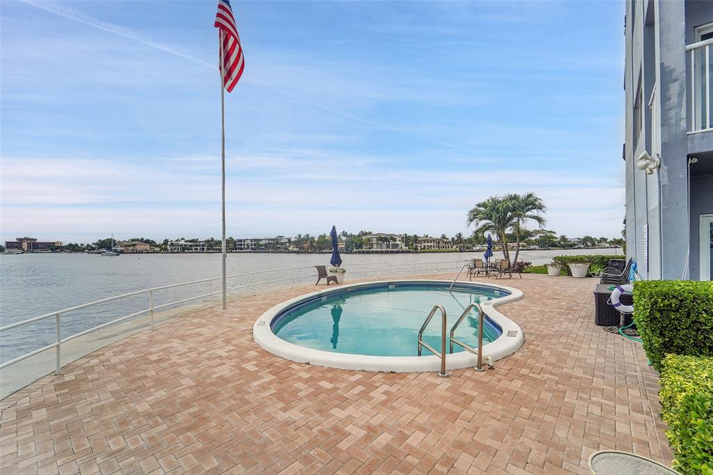1201 South Riverside Drive, Unit 204 Pompano Beach, FL 33062 - Photo 25 of 48 a view of a swimming pool with a lake view
