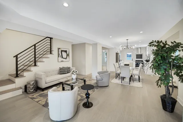 a living room with furniture and kitchen view
