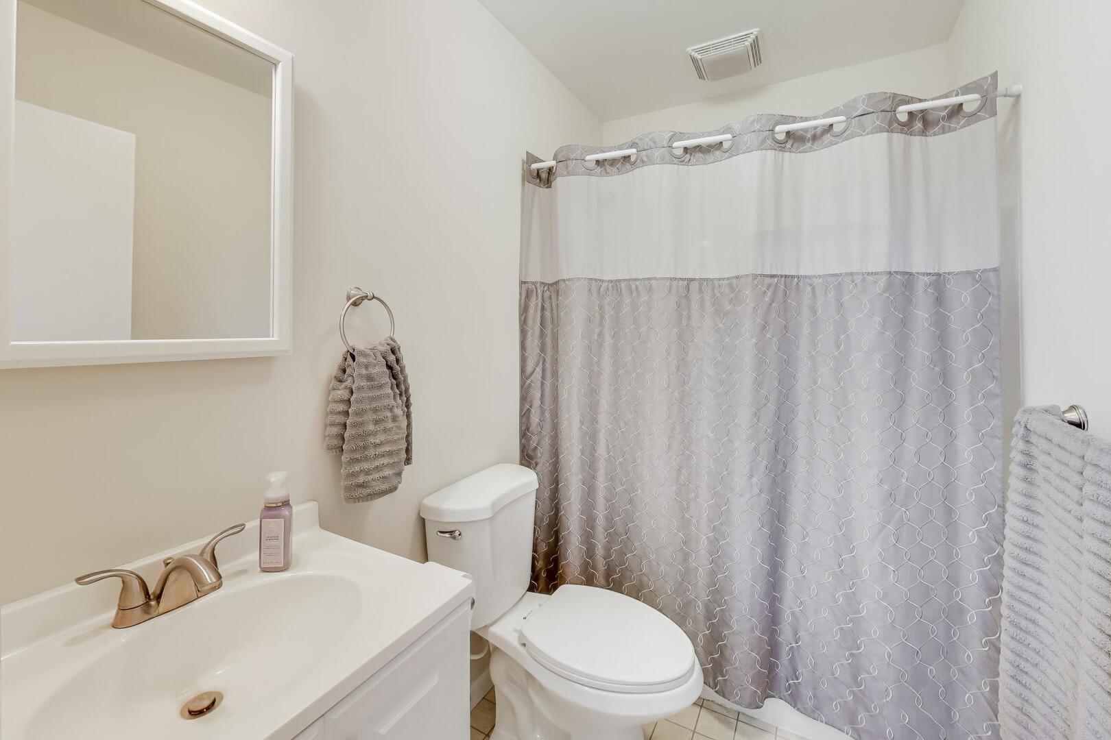 4N405 2nd Avenue Addison, IL 60101 - Photo 12 of 30 a bathroom with a sink a toilet and shower curtain