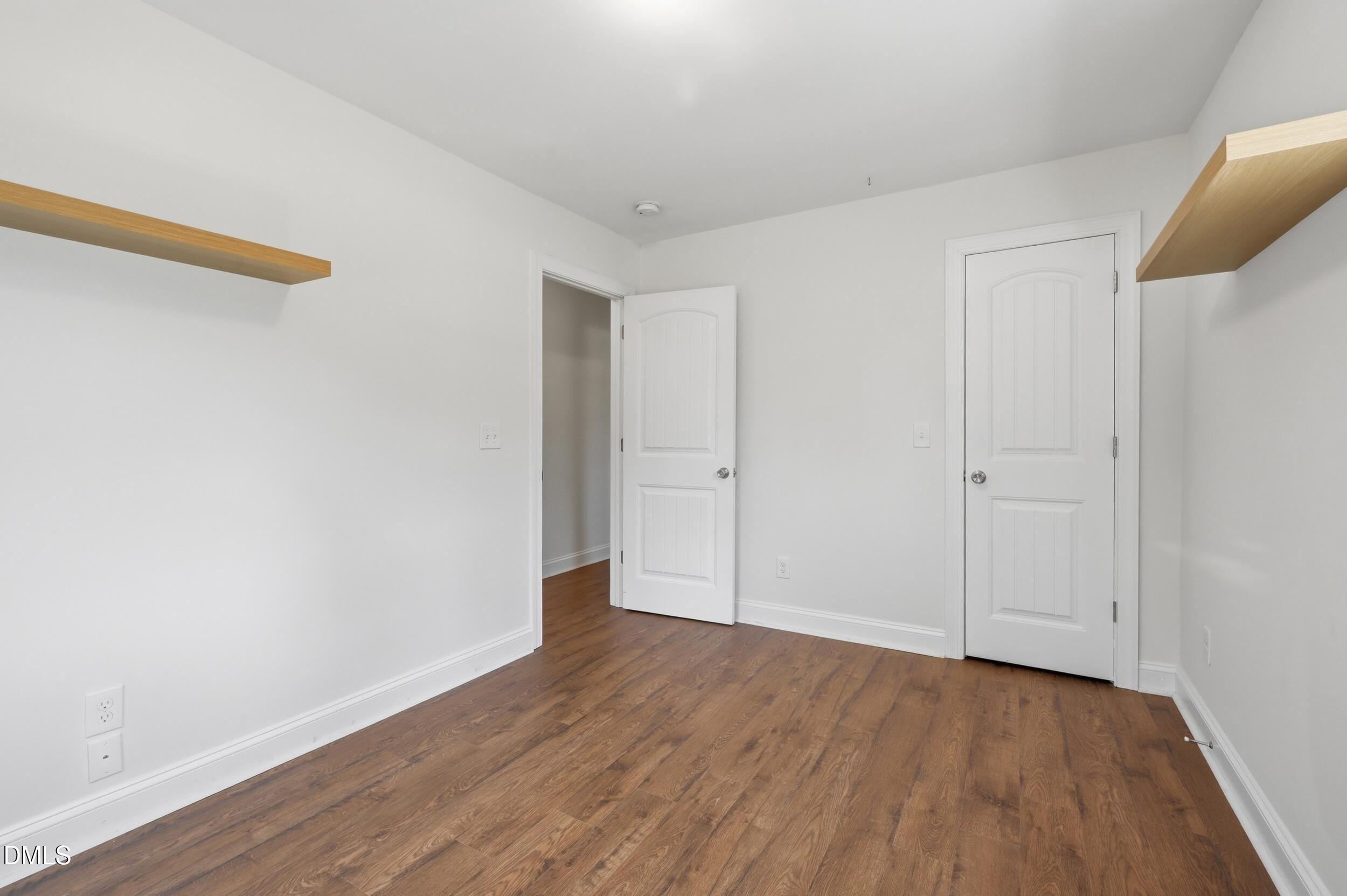 2301 Milburnie Road Raleigh, NC 27610 - Photo 19 of 23 a view of an empty room with wooden floor