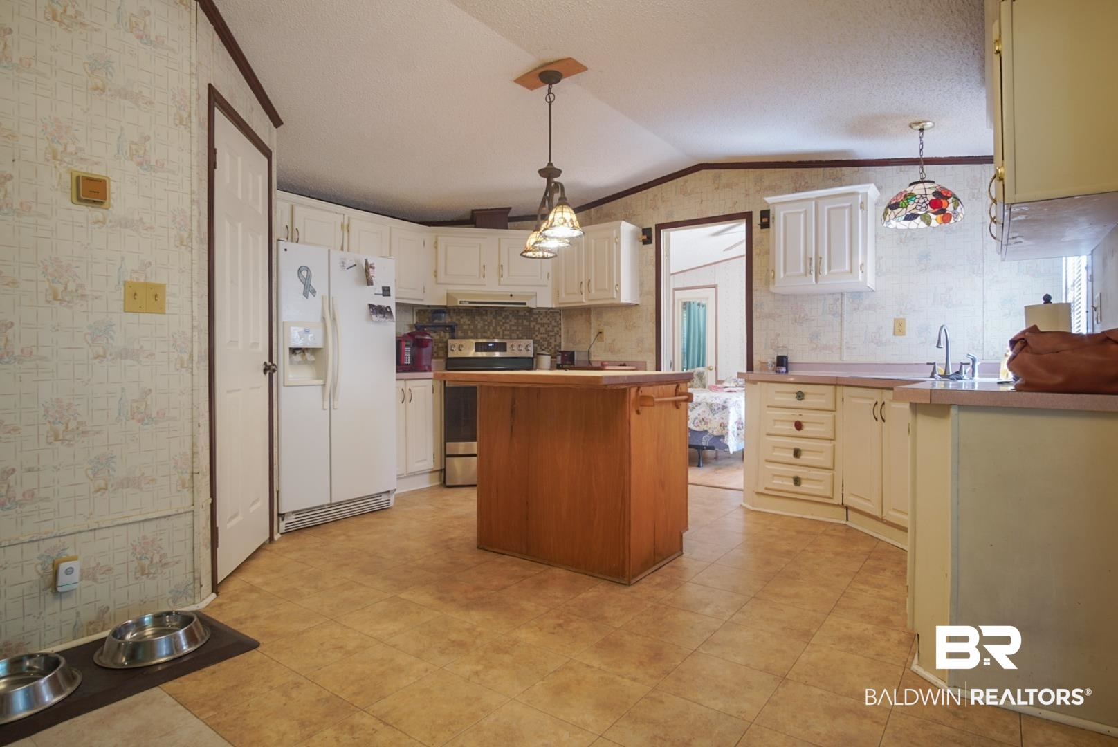 9190 County Road 97 Elberta, AL 36530 - Photo 18 of 53 Kitchen featuring lofted ceiling, a center island, electric stove, white refrigerator with ice dispenser, and pendant lighting