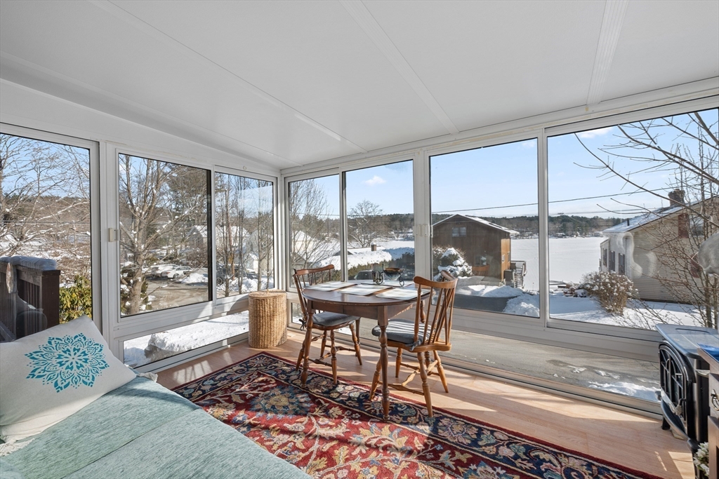5 Glen Echo Shore Road Charlton, MA 01507 - Photo 22 of 42 a living room with furniture and a floor to ceiling window