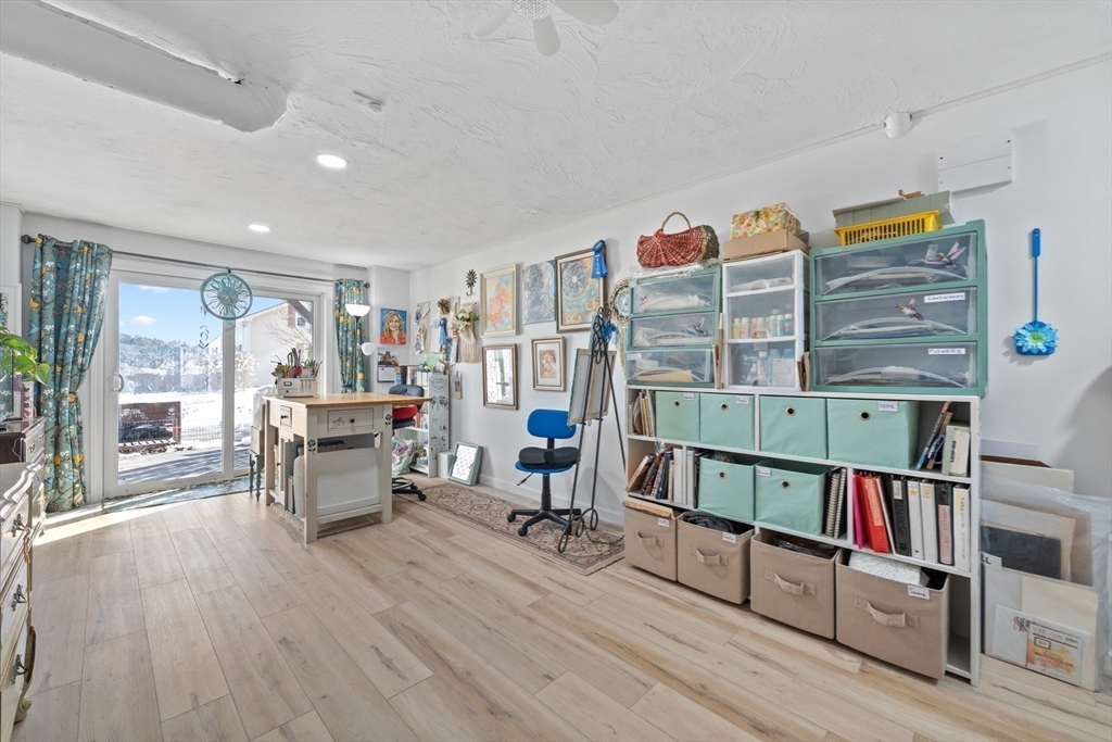 5 Glen Echo Shore Road Charlton, MA 01507 - Photo 24 of 42 a living room with lots of furniture and a book shelf