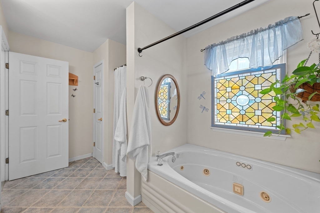 5 Glen Echo Shore Road Charlton, MA 01507 - Photo 29 of 42 a bathroom with a bathtub a window and a shower