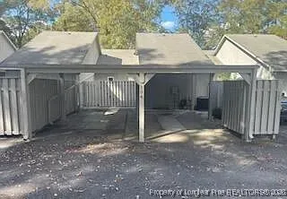 a view of a small house with wooden fence